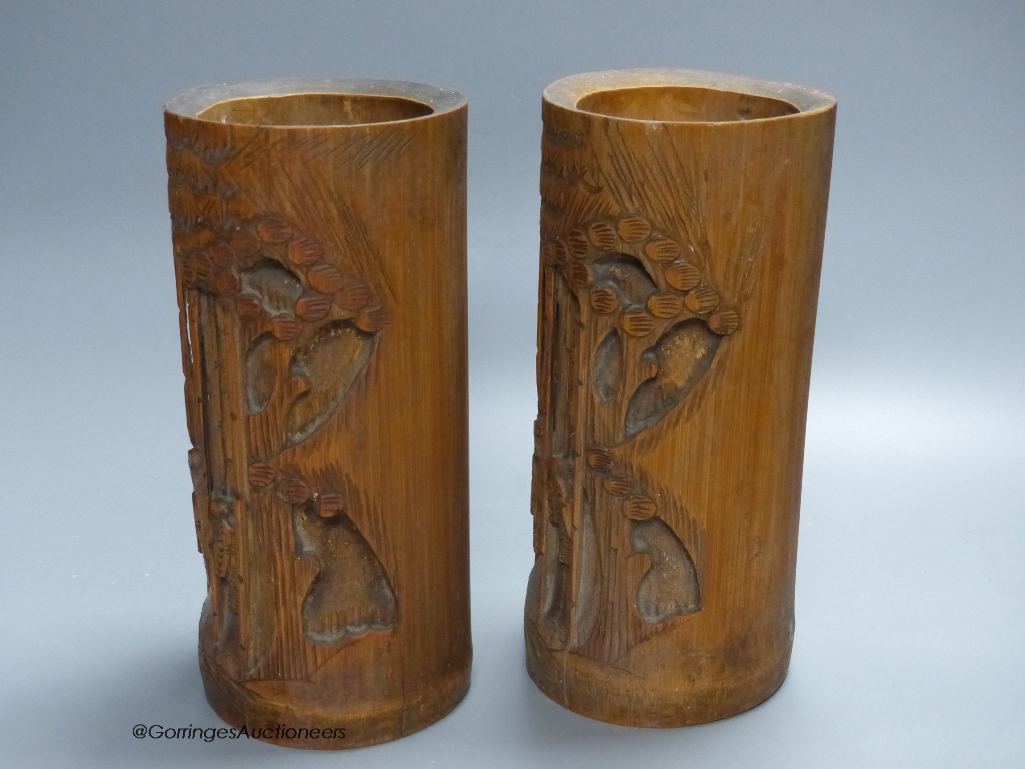 A pair of Chinese bamboo brush pots, carved with figures, signed to bases, height 21.5cm